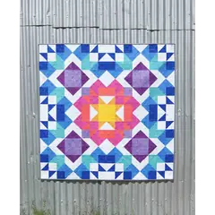 Aurora Quilt Pattern by Tied With A Ribbon - Quilt hung on corregated iron for effect